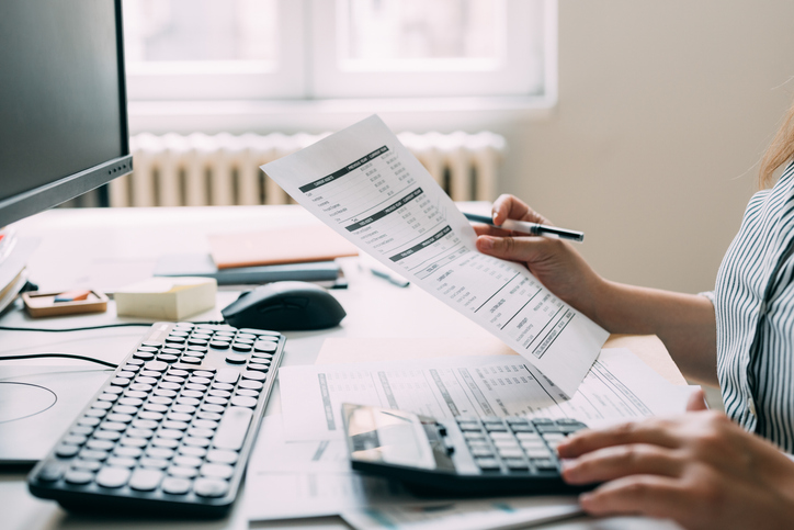 Unrecognizable Female Accountant Analyzing the Company's Financial Records